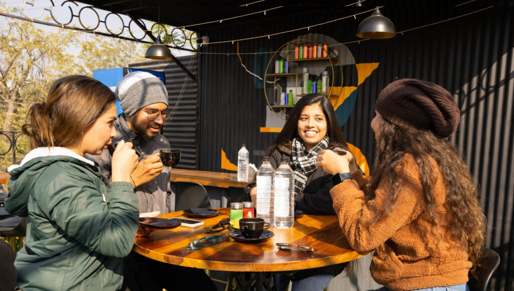 group of friends enjoy coffee and tea outdoors during guftugoo ( also written as guftugu, or guftagu or gufthagu)